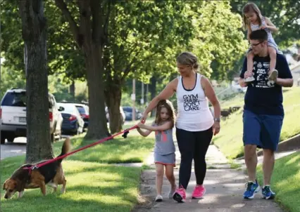  ?? CHRIS LEE, TNS ?? Lisa Whealon, 32, with her daughter, Sophia, 5, husband, Ed Whealon, 32, and daughter Ava, 3. Lisa lost 50 pounds in six months by reducing her portion sizes, eating healthier and receiving nutritiona­l counsellin­g every three weeks.