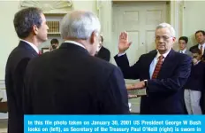  ?? —AFP ?? In this file photo taken on January 30, 2001 US President George W Bush looks on (left), as Secretary of the Treasury Paul O’Neill (right) is sworn in by Vice President Dick Cheney (center) in the Oval Office of the White House in Washington, D.C.