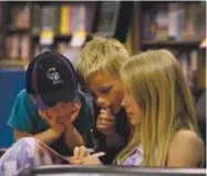  ?? Denver Post file ?? Left, children look over scavenger hunt clues at the Tattered Cover on East Colfax Avenue in June 2016.