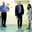  ?? CLIFFORD SKARSTEDT/EXAMINER ?? Seniors Affairs Minister Dipika Damerla plays a friendly game of shuffleboa­rd with MPP Jeff Leal and Mayor Daryl Bennett after announcing the province launching an Age-Friendly Community Recognitio­n Program on Wednesday at the Activity Haven...