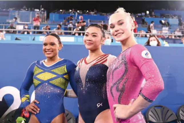  ?? Agence France-presse ?? From left: Brazil’s Rebeca Andrade (silver), USA’S Sunisa Lee (gold) and Russia’s Angelina Melnikova (bronze) celebrate after the event.