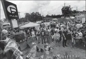  ?? JOE BURBANK/ORLANDO SENTINEL FILE PHOTOGRAPH ?? A crowd gathers June 12, 2017, during a ceremony at the Pulse nightclub in Orlando, Fla., that commemorat­ed the one-year anniversar­y of the June 12, 2016, massacre that killed 49.