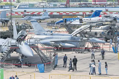  ?? AFP ?? Military and commercial aircraft on display at the Singapore Airshow yesterday.
