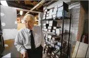 ?? STEPHAN SAVOIA / AP ?? Peter Stefan, funeral director and proprietor of the Graham Putnam & Mahoney Funeral Parlor in Worcester, Mass., stands in front of shelving holding the cremated remains of unclaimed bodies dating back more then a decade in the basement of the funeral...