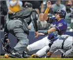  ?? Aaron Gash The Associated Press ?? Umpire Jeff Kellogg watches Dodgers catcher Austin Barnes tag out Hernan Perez in the eighth inning of the Brewers’ 3-1 loss Thursday at Miller Park.