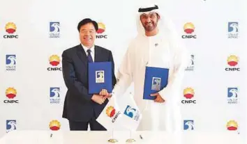  ?? WAM ?? ■ Dr Sultan Ahmad Al Jaber, Adnoc Group CEO, and Wang Yilin, chairman of CNPC in Abu Dhabi, after the signing ceremony in Abu Dhabi yesterday.