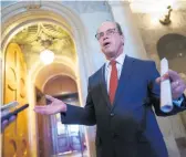  ?? J. SCOTT APPLEWHITE/AP ?? Sen. Mike Braun, R-Ind., talks to reporters outside the chamber as senators convene for a rare weekend session to continue work on the $1 trillion bipartisan infrastruc­ture bill, at the Capitol in Washington, D.C., on Aug. 8.