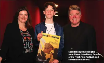  ??  ?? Sean Treacy collecting his award from Jane Foley, founder of the Fresh Film Festival, and comedian Pat Shortt.
