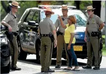  ?? AP ?? JoWanda Strickland-Lucas, of Aberdeen, Maryland, speaks to State Police near the perimeter of a scene where a shooting took place in Aberdeen.