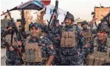  ??  ?? Iraqi forces celebrate Monday in Mosul after the “liberation” of the embattled city from Islamic State fighters.