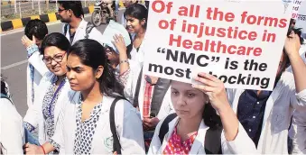  ?? PHOTO: PTI ?? Medical students observe black day during a protest rally against NMC in Bhubaneswa­r on Tuesday