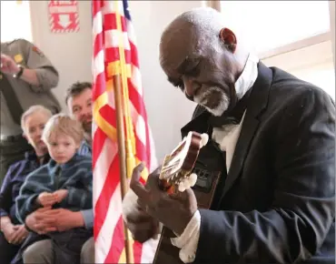  ??  ?? Joseph Becton, a musician and historian, plays the guitar during his presentati­on “Music of the Undergroun­d Railroad,” at an event at Hopewell Furnace.