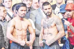  ??  ?? Philippine­s’ Manny Pacquiao (L) and Argentina’s Lucas Matthysse pose for pictures the after the weigh-in event in Kuala Lumpur on July 14, 2018, ahead of his world welterweig­ht boxing championsh­ip bout against Philippine­s’ Manny Pacquiao. — AFP photo