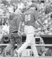  ?? Charles Fox / Tribune News Service ?? The Phillies’ Vince Velasquez takes part in the scene every pitcher hopes to avoid — leaving the field with a trainer after an abbreviate­d outing.