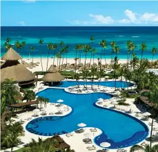  ?? ?? Shoreside setting of the Secrets Royal Beach Punta Cana, below; the pool winds through the resort, right