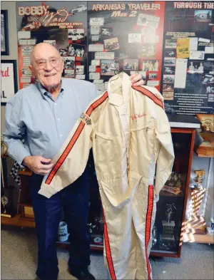  ?? TAMMY KEITH/RIVER VALLEY & OZARK EDITION ?? Bobby Ward of Conway, a member of two race-car halls of fame, holds one of only two uniforms he had during his 19-year career. Ward, who grew up in Bee Branch, started drag racing and transition­ed to stockcar racing in the 1950s, winning 369 feature...