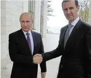  ?? /Reuters ?? Bedding-in: Russian President Vladimir Putin, left, shakes hands with Syrian President Bashar al-Assad.