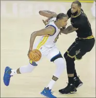  ?? AP PHOTO ?? Golden State Warriors forward Kevin Durant drives on Cleveland Cavaliers forward LeBron James during Game 2 of the NBA Finals in Oakland, Calif. on Sunday.