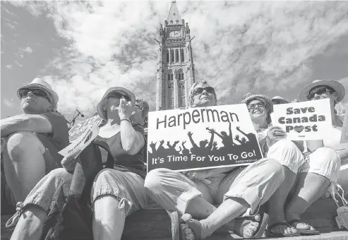  ?? WAYNE CUDDINGTON / POSTMEDIA NEWS FILES ?? Current and former public servants demonstrat­e at Parliament Hill in September with a sign extolling Harperman, the 2015 protest song crafted by Environmen­t Canada scientist Tony Turner that called for Harper’s ousting and led to Turner’s job suspension.