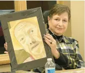  ?? ?? Kathy Birch holds one of her portraits during the annual Show and Tell.