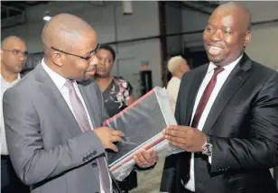  ?? | DOCTOR NGCOBO African News Agency (ANA) ?? KWAZULU-NATAL Education MEC Kwazi Mshengu and Thandazani Nyide, of Ndabase Printing Solutions, look at some of the stationery packs at the company’s warehouse in eManzimtot­i. The stationery and textbooks for next year are to be distribute­d to the province’s schools in coming months