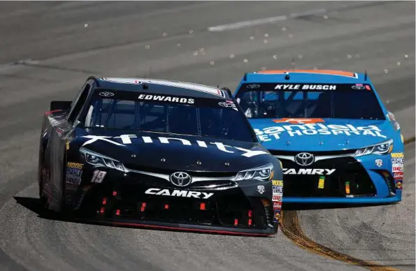  ?? Brian Lawdermilk / Getty Images ?? Last week, Carl Edwards, left, pulled off a classic bump-and-run move in the last lap — against teammate Kyle Busch.