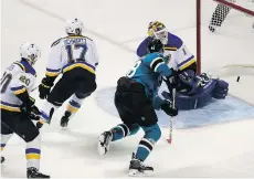  ?? EN/GETTY IMAGES CHRISTIAN PETERS- ?? Tomas Hertl of the San Jose Sharks scores in the third period against Brian Elliott of the St. Louis Blues during the Sharks’ 3-0 win in Game 3 of the Western Conference final on Thursday in San Jose.