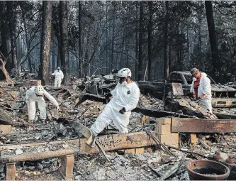  ?? JOHN LOCHER THE ASSOCIATED PRESS ?? Search and rescue personnel check a home for human remains in the aftermath of the Camp fire in Paradise, Calif. As U.S. President Donald Trump toured affected areas, outgoing Democratic Gov. Jerry Brown and the incoming Democratic governor said they were pleased with the president’s support.