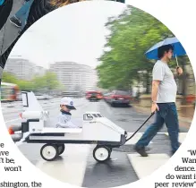  ??  ?? Tomas Carbonell pulls his son, Felipe CarbonellB­oon in a mock Nasa space shuttle as science advocates gathered on the Mall, Washington.