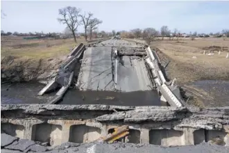  ?? AP PHOTOS/RODRIGO ABD ?? A bridge destroyed by the Ukrainian army to prevent the passage of Russian tanks is seen Monday near Brovary, on the outskirts of Kyiv, Ukraine.