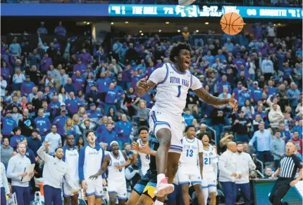  ?? FRANK FRANKLIN II/AP ?? Seton Hall’s Kadary Richmond dunks the ball in front of Marquette’s Stevie Mitchell during the second half Jan. 6 in Newark, New Jersey. Seton Hall won 78-75.