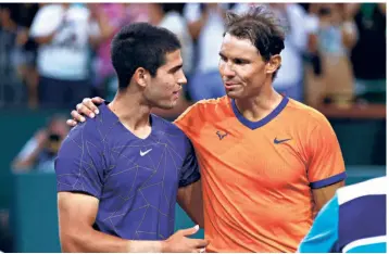  ?? AFP ?? The King’s rule:
Rafael Nadal and Carlos Alcaraz exchange pleasantri­es after their semifinal match in Indian Wells. Alcaraz didn’t defeat Nadal this time, but he clearly possesses the game, athleticis­m, and determinat­ion to win major titles.