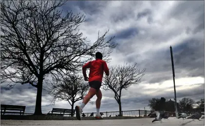  ?? CHRIS CHRISTO — BOSTON HERALD ?? A runner makes their way along William J. Day Blvd in south Boston on Sunday.