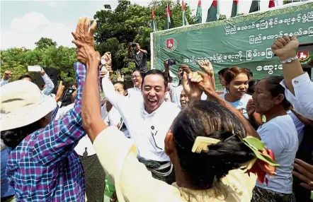  ??  ?? Reason to celebrate?: Wai Lwin, former defence minister and member of the Central Executive Committee of the military-backed Union Solidarity and Developmen­t Party (centre), dancing with party members after a ceremony condemning terrorism in Rakhine...