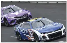  ?? (AP/Morry Gash) ?? Justin Haley (right) and Denny Hamlin drive during practice for today’s NASCAR Cup Series auto race at the Grant Park 220. Later in the day, Hamline won the race pole, edging Tyler Rddick on the 12-turn, 2.2-mile course.