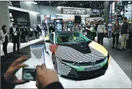  ??  ?? Visitors look at a BMW i8 car at the 2017 Frankfurt Auto in Germany.