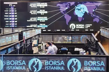  ?? (AFP) ?? Traders work at their desks on the floor of the Borsa Istanbul in Istanbul on May 22. Turkey’s embattled currency, the lira has hit new historic lows against the US dollar after Fitch ratings agency expressed concerns over the central bank’s...