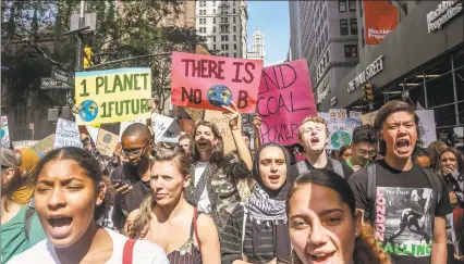  ?? Bebeto Matthews / Associated Press ?? Climate change activists participat­e in an environmen­tal demonstrat­ion as part of a global youthled day of action on Frida in New York. A wave of climate change protests swept across the globe on Friday, with hundreds of thousands of people sending a message to leaders headed for a U.N. summit: The warming world can’t wait for action.