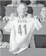  ?? Chronicle file ?? Bush shows off the Astros jersey he was given by the team on June 12, 2004.