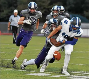  ?? BARRY TAGLIEBER - FOR DIGITAL FIRST MEDIA ?? Great Valley’s Brendan O’Donnell has the ball stripped by Phoenixvil­le’s Jordan Ford during last Friday night’s game.