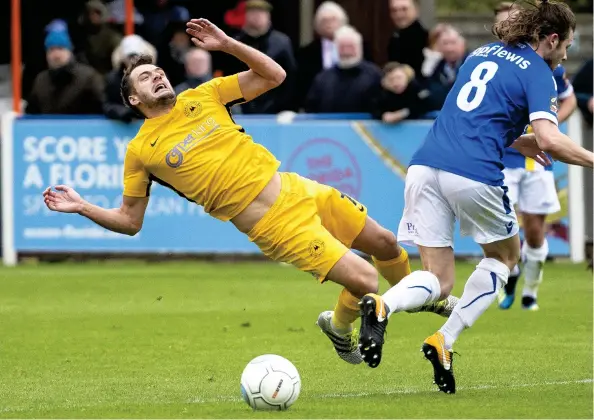  ??  ?? Ryan Dickson feels the full force of a Matthew Lench tackle during Torquay United’s win over Wealdstone on SaturdayJa­mes Fearn/PPAUK