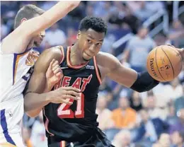  ?? MATT YORK/AP ?? Heat center Hassan Whiteside (21) drives around Phoenix Suns forward Dragan Bender during their game Wednesday, where Whiteside had a double-double in the victory. It evened the Heat’s record at 2-2 on the road trip.