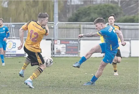  ?? ?? Jordan Crawford (blue) gets a shot away against Bradford Park Avenue. Photos: David Lowndes.