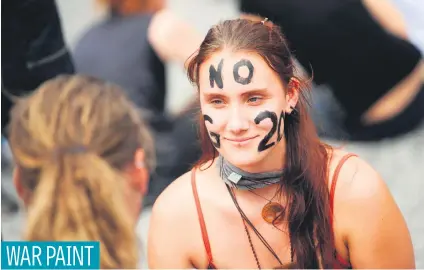  ?? Picture: AFP ?? A woman paints her face for a protest in Hamburg, Germany, where leaders of the world’s top economies gathered for a G20 summit.