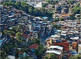  ??  ?? Exploring: The favela slums in Rio de Janeiro, living off the land and sea with Bear Grylls in 2018, and pieces of the Berlin Wall after the fall of communism