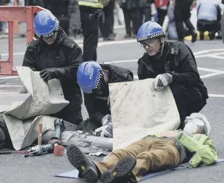  ??  ?? 0 Police tackle Extinction Rebellion protesters in Edinburgh yesterday during a day of climate change action