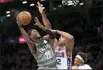  ?? MARY ALTAFFER - AP ?? Nets guard Caris LeVert (22) goes to the basket against 76ers center Al Horford (42) during the second half Monday in New York.