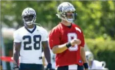  ?? THE ASSOCIATED PRESS ?? Saints running back Adrian Peterson (28) stands behind quarterbac­k Drew Brees (9) during a practice in Metairie, La., Thursday.