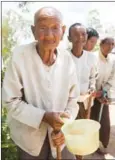  ?? KIMBERLEY MCCOSKER ?? Elderly beggars crowd a road in Takeo. The government yesterday released a policy meant to address care for the Kingdom’s elderly population.