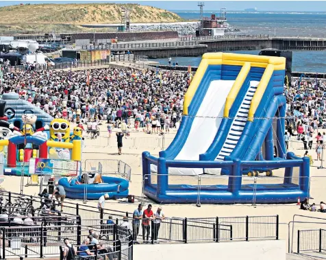  ??  ?? The bouncy castles on a packed Gorleston beach, pictured last week. Above left, police at the site after the incident